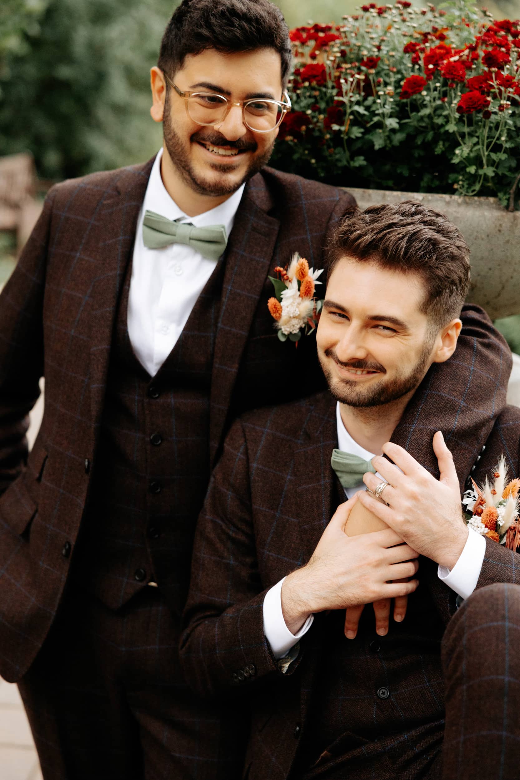 two grooms looking at the camera smiling
